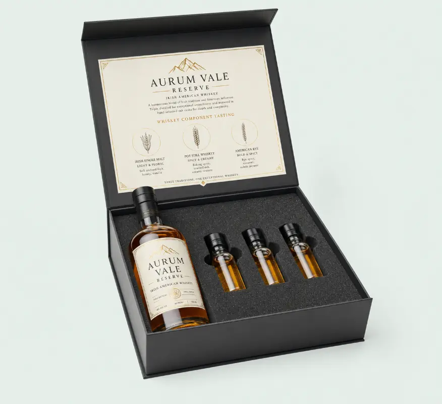 Black rigid liquor packaging box with a whiskey bottle and four sample vials.